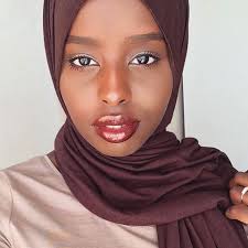 brown girl with a stunning dark color hijab